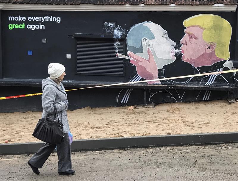 Un grafiti en Lituania que muestra al presidente electo estadounidense, Donald Trump, y al presidente ruso, Vladímir Putin, mientras comparten el humo de un cigarro. EFE/Roman Pilipey.